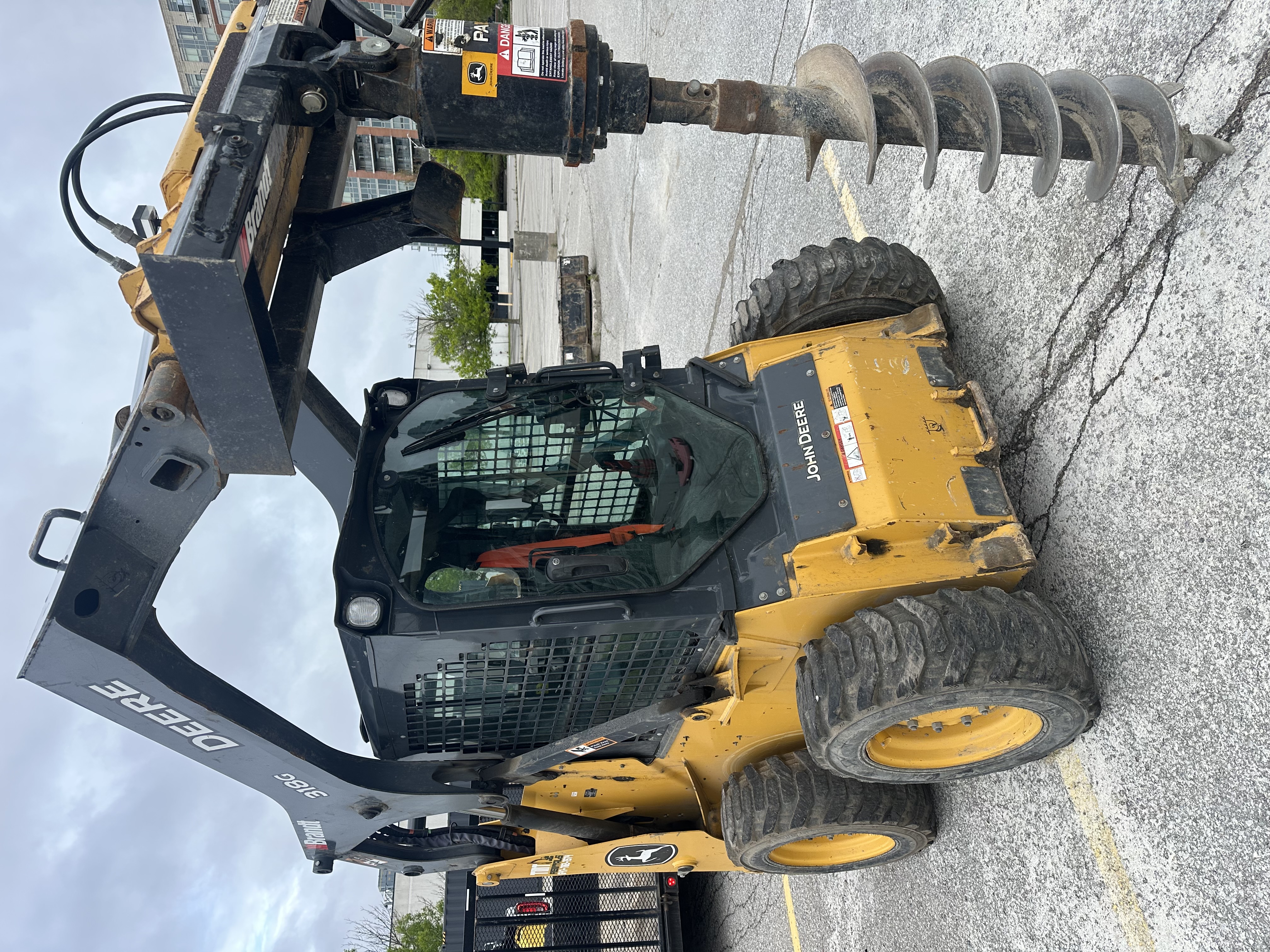 John Deere 318G with Auger