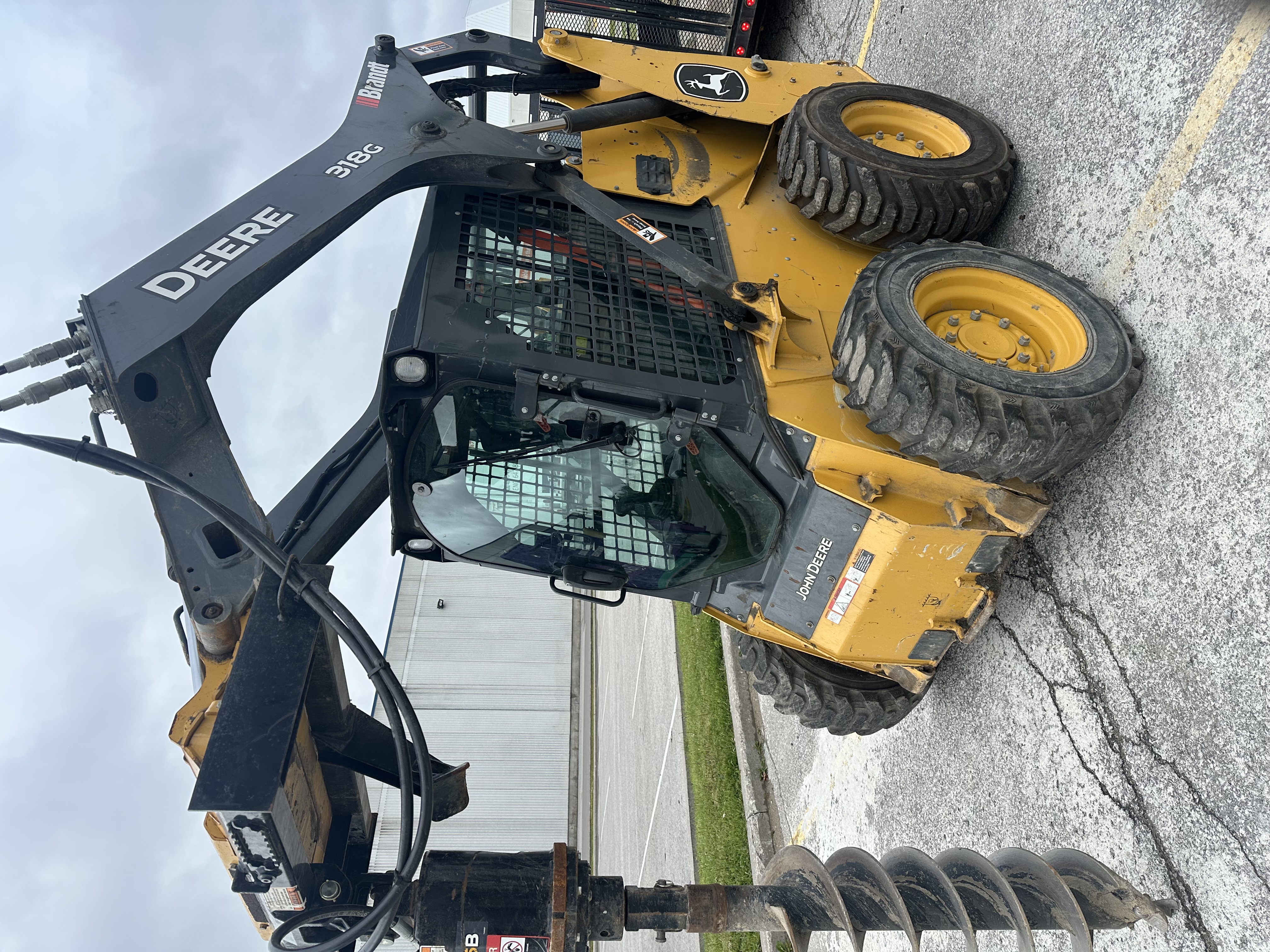 John Deere 318G with Auger